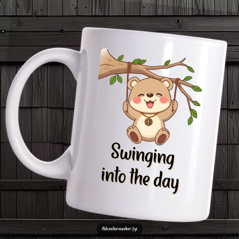 Funny Bear Cub Compass Mug. A joyful bear cub wearing a compass necklace swings from a branch.