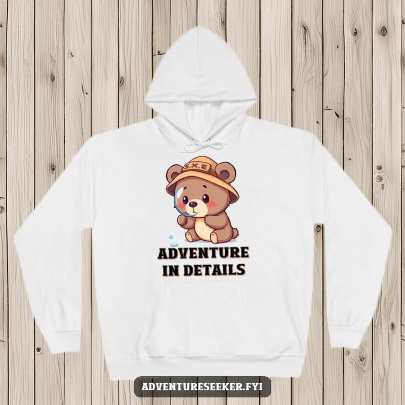 Funny bear cub explorer hoodie, showing a focused cub in an explorer hat examining a dewdrop with a magnifying glass.