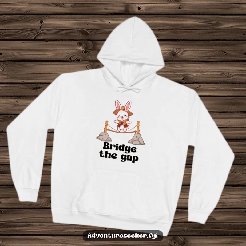 Funny hoodie featuring a cheerful rabbit scout character bravely crossing a wobbly rope bridge, offering warmth and a humorous design.