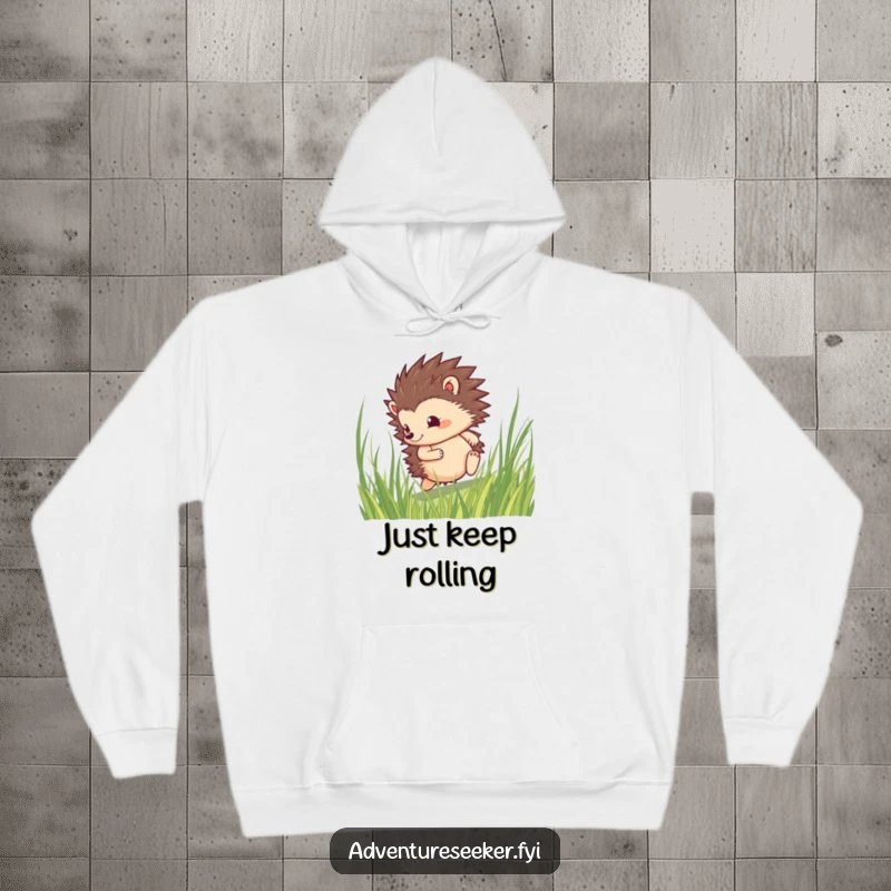 Funny hedgehog hoodie featuring a determined character rolling through tall grass, perfect for cozying up after an adventure.