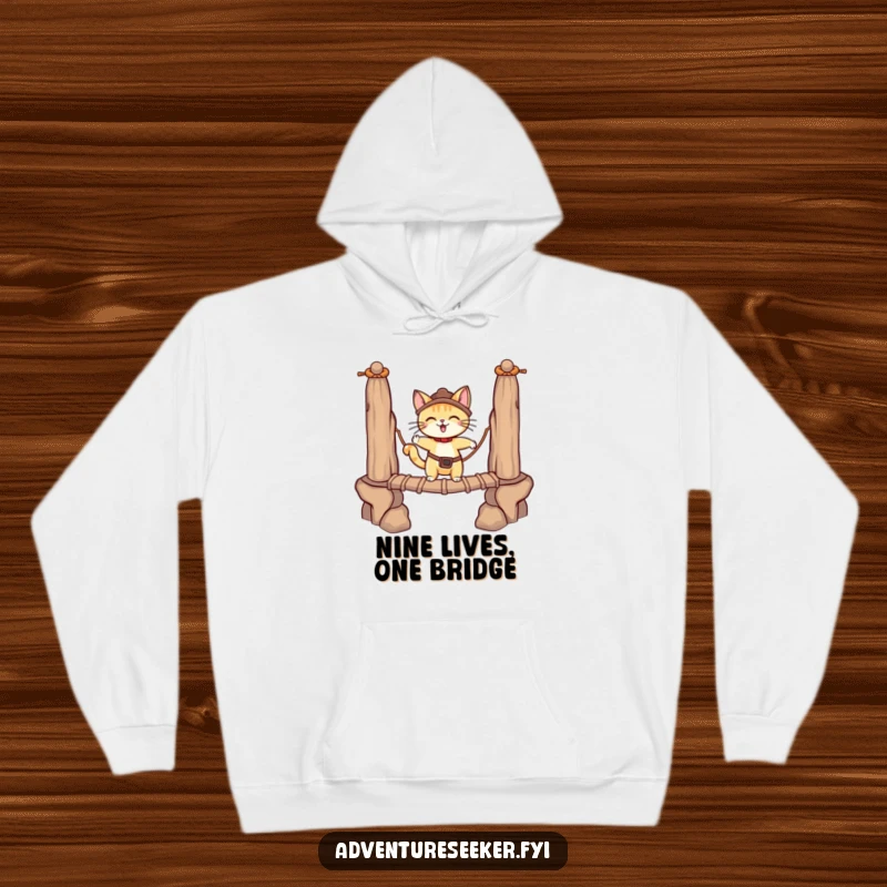 Funny adventurous cat in a hoodie, balancing on a rope bridge with determination. A warm funny gift.