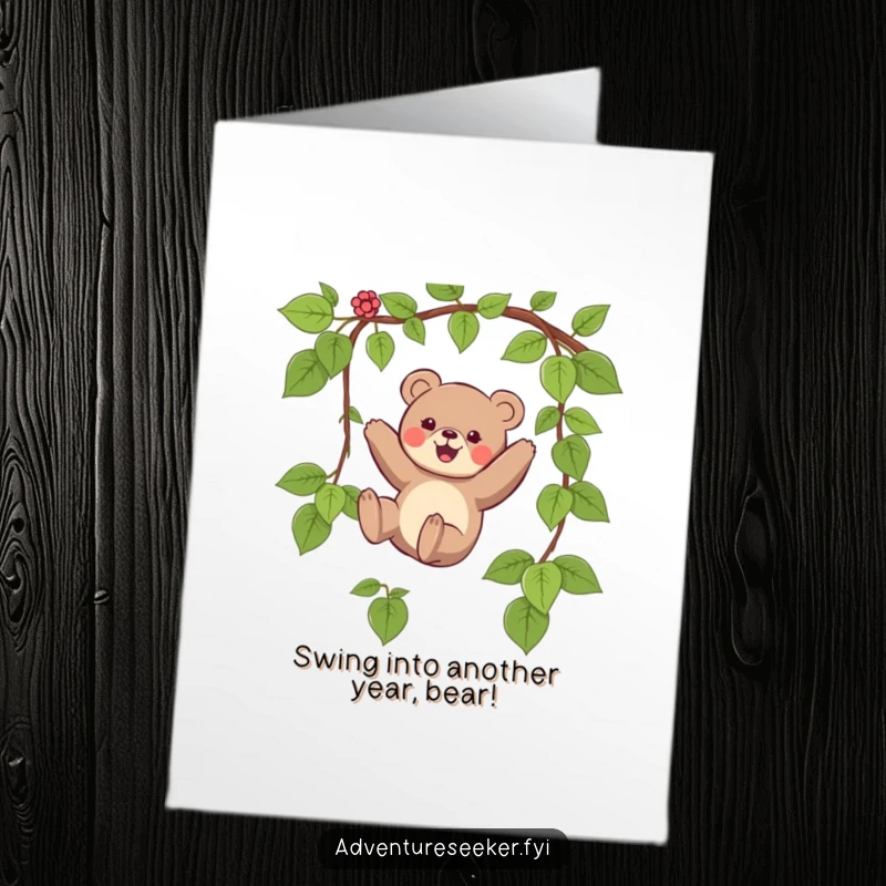 Funny free printable birthday card showing a small bear gleefully swinging from a vine, ready for a wild celebration.