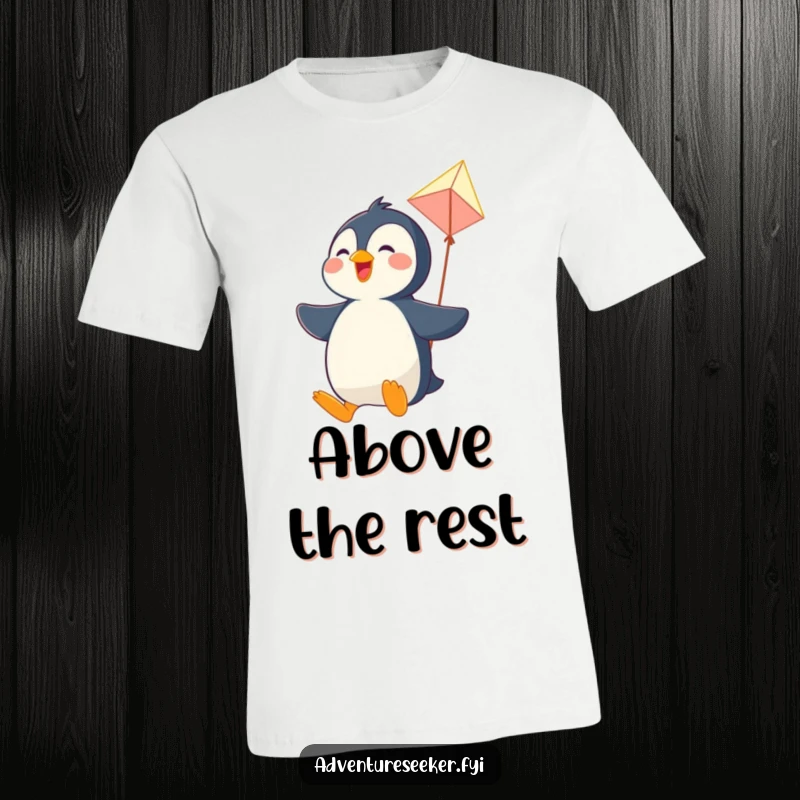 Funny t-shirt featuring a joyful penguin character soaring high in the sky on a quirky, homemade kite, embodying freedom.