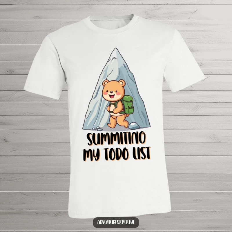 Funny t-shirt featuring a cheerful bear with a backpack, smiling as it ascends a towering mountain, perfect for outdoor enthusiasts.