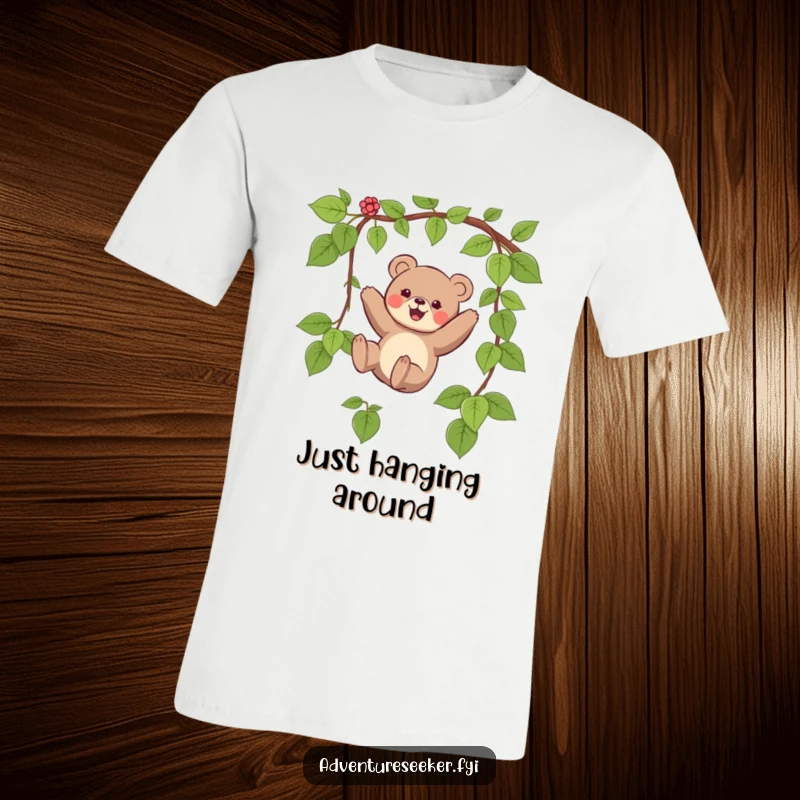 Funny T-shirt showcasing a small bear character joyfully swinging on a vine, capturing a moment of boundless fun.