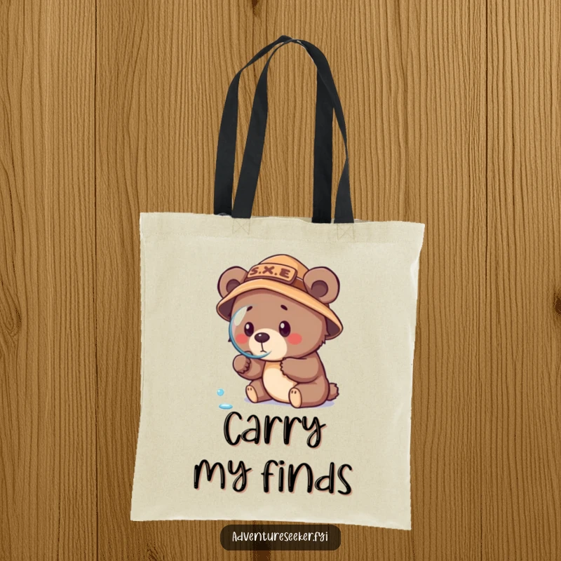 Funny bear cub explorer tote bag, featuring a cub in an explorer hat with a magnifying glass looking at a dewdrop.